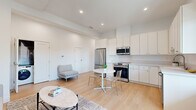 Located on 3rd Street in the heart of Santa Monica, this thoughtfully designed 1-bedroom, 1-bathroom unit offers a clean, modern aesthetic throughout. Light wood flooring flows seamlessly across the entire space, complementing the bright white walls and recessed lighting that give the home an airy, open feel.

The open-concept kitchen and living area serves as the heart of the unit. The kitchen is outfitted with crisp white cabinetry reaching toward the ceiling, a full suite of stainless steel appliances including a refrigerator, range, microwave, and dishwasher, and a white quartz countertop. A compact dining area sits adjacent, ideal for casual meals. The living space provides a comfortable, flexible area with room for seating and relaxation.

The spacious bedroom features two large windows that bring in generous natural light and offer outdoor views, creating a bright and welcoming atmosphere. A wide mirrored sliding-door closet adds both storage and the illusion of even more space.

The bathroom is finished with large-format tile in the glass-enclosed walk-in shower, warm wood-tone flooring, and a clean white vanity with ample counter space. A dedicated in-unit laundry closet adds everyday convenience. A smart thermostat is also included throughout the unit.