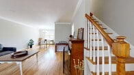 Located at 806 Morris Tpke in the desirable community of Short Hills, NJ, this multi-level home offers a thoughtfully organized layout across three floors. The main living level features warm hardwood flooring throughout, highlighted by a spacious living room anchored by a classic brick wood-burning fireplace and elegant crown molding. Natural light filters in through multiple windows, creating a bright and inviting atmosphere. The adjacent dining area is framed by crown molding and a stylish chandelier, while the galley-style kitchen is equipped with dark granite countertops, warm wood cabinetry, a gas range, and a built-in wine rack. A graceful staircase with white balusters and a rich wood banister connects all three levels. The generously sized primary bedroom features gleaming hardwood floors and multiple windows that flood the room with natural light. The updated bathrooms include a sleek walk-in glass shower with large-format gray tile. A dedicated laundry room with full-size washer and dryer, finished in matching large-format tile, adds everyday convenience. Additional closets and hallways throughout the home provide ample storage, completing this well-rounded and comfortable residence in one of New Jersey's most sought-after communities.