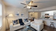 This well-designed 3-bedroom, 2-bathroom single-floor residence offers a thoughtful layout that balances comfort and functionality throughout. The open living area serves as the heart of the home, featuring wood-look flooring, a ceiling fan with integrated lighting, and neutral tones that create a bright and welcoming atmosphere. Coastal-inspired décor adds a cohesive sense of style to the space.

The galley-style kitchen is efficiently designed with white cabinetry, granite-look countertops, a stainless steel sink, and a full suite of appliances including a refrigerator, electric range, microwave, and dishwasher. Wood-look flooring continues throughout, and an adjacent dedicated dining area provides a defined space for meals, complete with its own ceiling light fixture.

Each of the three bedrooms offers carpeted flooring and its own distinct character. The primary and secondary bedrooms feature windows that invite natural light and outdoor views, while all bedrooms include closet storage. The two full bathrooms are finished with granite-look vanity countertops, white cabinetry, tub-shower combinations with tiled surrounds, and wood-look flooring, providing clean and functional spaces for daily routines.