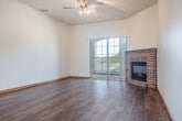 Located at 915 Ellis Ave in Baraboo, Wisconsin, this single-floor, 2-bedroom, 2-bathroom home offers a well-organized layout with generous living space. The open-concept living and dining area is anchored by a striking brick fireplace and sliding glass doors that lead to a private patio overlooking a tree-lined exterior. A ceiling fan enhances the airy feel of the living room, which flows seamlessly into the kitchen. The kitchen is equipped with warm oak cabinetry, a peninsula with pendant lighting, a stainless steel range, dishwasher, and over-the-range microwave. A dedicated pantry provides additional storage convenience. Hardwood-style flooring extends throughout the entire home, adding warmth and visual continuity. The primary bedroom is a comfortable size and features a large arched window that brings in ample natural light and outdoor views of the surrounding greenery. The second bedroom is equally well-lit with its own window. Both bathrooms are clean and functional, with one featuring a full tub-shower combination. The home also includes five closets, offering exceptional storage throughout. A hallway connects the living areas to the bedrooms and bathrooms, completing this practical and inviting floor plan.