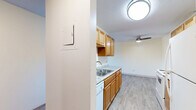 Located at 2150 Wilson Ave in Saint Paul, MN, this one-bedroom, one-bathroom residence offers a well-organized and functional floor plan across a single level. The open-concept living, dining, and kitchen area serves as the heart of the home, with light-toned luxury vinyl plank flooring running through the kitchen and a ceiling fan overhead in the dining and living space. The kitchen is equipped with warm honey-toned wood cabinetry, granite-look countertops, a stainless steel sink, a white electric range, a refrigerator, and a dedicated walk-in pantry closet for generous storage. A large sliding glass door in the living area fills the room with natural light and opens onto a private balcony overlooking mature trees, providing a comfortable outdoor retreat. The living room features plush carpet and a baseboard heating system. The bedroom is a well-proportioned, carpeted retreat with ample natural light and includes a sliding-door closet with built-in shelving, plus additional closet space nearby. The bathroom features wood-look vinyl flooring, a dark-toned vanity, and a full tiled tub-and-shower combination. With three total closets throughout, this residence offers notable storage capacity relative to its footprint.