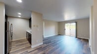 Located at 3472 El Camino Real in Santa Clara, California, this single-floor unit offers a well-organized layout with a clean, contemporary aesthetic throughout. The open living area is finished with durable wood-style plank flooring and neutral warm-toned walls, creating a bright and welcoming atmosphere. A ceiling fan adds practical comfort to the main living space, while a sliding glass door allows natural light to pour in and provides direct access to a private balcony with outdoor views.

The kitchen is efficiently designed in a galley configuration, featuring dark espresso cabinetry, white countertops, and a full suite of stainless steel appliances including a refrigerator, microwave, and range. A peninsula counter opens toward the living area, providing a natural transition between spaces.

The bedrooms are carpeted for comfort and include generous closet space with mirrored sliding doors. Corner windows in one bedroom offer additional natural light. Baseboard heating is present throughout the carpeted rooms.

The bathroom is well-appointed with wood-style flooring, a dark-toned vanity with a white countertop, dual mirrors, a built-in shelving unit, and a tub and shower combination enclosed by sliding glass doors. The overall unit presents a functional and tastefully updated living environment.