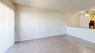 Located in the heart of West Hollywood, this 2-bedroom, 2-bathroom residence at 1342 N Poinsettia Place offers a well-organized, single-floor layout designed for comfortable everyday living. The living room is bright and airy, featuring light wood-style flooring, a textured ceiling, and a large sliding glass door fitted with vertical blinds that opens to the outdoors, flooding the space with natural light. Adjacent to the living area, the galley-style kitchen is thoughtfully appointed with white shaker cabinetry, grey countertops, a stainless steel double-basin sink, and a full suite of stainless steel appliances including a gas range, microwave, and refrigerator — all complemented by light wood-look flooring. The primary bedroom is generously proportioned, featuring plush carpeting, a textured ceiling, and a wide mirrored sliding closet that enhances the sense of space. The second bedroom also offers carpeted floors and its own mirrored closet. Both bathrooms are clean and functional, with one featuring a full soaking tub with a tiled surround and the other offering a vanity with a grey countertop and framed mirror. A connecting hallway ties all rooms together efficiently, completing this well-appointed Los Angeles residence.
