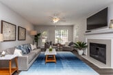 Located at 55 Sweetberry Ct in Alpharetta, GA, this single-floor residence offers a thoughtfully designed layout with a seamless flow between its main living spaces. The living room serves as the heart of the home, centered around a white-paneled fireplace and anchored by wood-style flooring. Large windows invite abundant natural light and provide outdoor views, while a ceiling fan adds comfort overhead. The space opens toward a dedicated dining area, highlighted by a stylish pendant light fixture and additional wood-style flooring, creating an inviting setting for meals. The galley-style kitchen features white cabinetry with modern hardware, granite-look countertops, and stainless steel appliances including a gas range, microwave, and dishwasher — offering a functional and clean workspace. Two carpeted bedrooms provide restful retreats, each benefiting from large windows that bring in natural light. The full bathroom is finished with white vanity cabinetry, granite-look countertops, a well-lit mirror, and a shower-tub combination. Textured ceilings are consistent throughout, and the overall design palette of soft neutrals and warm wood tones contributes to a cohesive, welcoming ambiance throughout the residence.