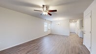 Located at 6205 NW Hutchens Rd in Highfill, Arkansas, this single-story, 5-bedroom, 2-bathroom home offers a clean, modern aesthetic throughout its thoughtfully arranged floor plan. The living room serves as the heart of the home, featuring wood-look luxury vinyl plank flooring, a ceiling fan with light fixture, and a chandelier accent that adds a touch of elegance. Natural light filters in through windows fitted with blinds, creating a bright and welcoming atmosphere.

The galley-style kitchen is well-appointed with gray shaker-style cabinetry, white countertops, a stainless steel sink, and black stainless appliances including an electric range, microwave, and refrigerator. Recessed lighting and light wood-look flooring keep the space feeling fresh and functional.

The five bedrooms are finished consistently with the same wood-look flooring and ceiling fans. The primary bedroom includes a walk-in closet, offering practical storage. Additional bedrooms provide comfortable, versatile spaces connected via a central hallway.

Both bathrooms feature wood-look flooring, gray vanity cabinetry, white countertops, and tub-shower combinations with brushed nickel fixtures and hardware, maintaining the home's cohesive, contemporary style throughout.
