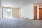 Located at 931 Harrington Dr in Madison, WI, this single-floor residence offers 2 bedrooms and 3 bathrooms within a well-appointed, open layout. The heart of the home is a combined kitchen, dining, and living area that flows seamlessly together. The kitchen is equipped with warm oak cabinetry, stainless steel appliances — including a refrigerator and range — and a distinctive octagonal center island with a laminate countertop, all set on hardwood-style flooring. The open living area extends comfortably from the kitchen, featuring plush carpeting and a ceiling fan that adds both function and character. Sliding glass doors lead to a private patio with views of the surrounding landscaping and neighboring buildings. Both bedrooms are carpeted and well-sized, with the primary suite featuring vaulted ceilings and a ceiling fan. The space benefits from an impressive five closets throughout, including a large walk-in with wire shelving. The bathrooms include wood-look tile flooring and natural light from windows. Warm oak door and window trim carries consistently throughout the home, lending a cohesive, welcoming aesthetic. An entrance area completes the thoughtful floor plan.