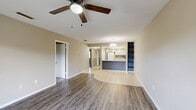 This classic 2-bedroom, 2-bathroom residence in Melbourne, Florida offers a well-organized single-floor layout designed for comfortable everyday living. The open-concept living room greets you with durable wood-look plank flooring, a textured ceiling, a ceiling fan, and a sliding glass door that leads to a private balcony with outdoor views — filling the space with natural light.

The kitchen is a standout feature, showcasing a wraparound peninsula with a sleek white countertop, a stainless steel sink, pendant lighting, a mosaic tile backsplash, white cabinetry, and a skylight that brightens the cooking area. A white refrigerator, electric range, and microwave complete the functional setup.

Both bedrooms are carpeted and equipped with ceiling fans, offering a comfortable retreat. The generously sized primary bedroom provides ample space and is served by a dedicated bathroom featuring a walk-in shower. The second bedroom benefits from a window with outdoor views. A second full bathroom includes a shower-tub combo, vanity with under-sink storage, and tile flooring.

Additional highlights include a dedicated laundry room with a full-size washer and dryer, two closets for storage, and a welcoming entrance. The thoughtful layout makes efficient use of the available space throughout.