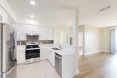 Located at 1029 W 223rd St in Torrance, CA, this well-designed 2-bedroom, 2-bathroom single-story residence offers a thoughtfully planned layout with clean, modern finishes throughout. The open-concept kitchen flows seamlessly into the living area and is outfitted with crisp white shaker cabinets, quartz countertops, a mosaic tile backsplash, stainless steel appliances including a range and dishwasher, and a stainless steel sink — all set atop light tile flooring. The adjacent living area extends the open feel with warm light wood-style flooring, neutral warm-toned walls, and a sliding glass door that invites abundant natural light. The primary bedroom is a comfortable retreat with light hardwood flooring and direct access to a sliding glass door. The second bedroom features a bright window with natural light and the same light wood flooring. Both bathrooms are finished in a consistent, clean aesthetic with white cabinetry, quartz vanity tops, tub-shower combos, and light linear tile flooring. A dedicated closet provides additional storage. Recessed lighting, visible HVAC vents, and clean white trim complete the refined, move-in-ready interior of this Torrance residence.