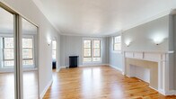 Located in Chicago's vibrant Uptown neighborhood, this 1-bedroom, 1-bathroom residence at 901 W Argyle St blends classic architectural character with thoughtful updates. Hardwood floors run throughout, complemented by crown molding and soft neutral-gray walls that create a cohesive, inviting atmosphere.

The spacious living room is a standout, featuring a decorative fireplace with a detailed white mantel, multiple windows that invite generous natural light, and a classic cast-iron radiator. Distinctive Gothic-style arched passageways connect the hallways to adjacent rooms, adding a unique architectural touch rarely found in the city.

The bedroom offers a comfortable footprint, a ceiling fan, a window with neighborhood views, and its own cast-iron radiator, maintaining the home's period character. A dedicated closet provides practical storage.

The galley kitchen is efficiently laid out with dark cabinetry, granite countertops, stainless steel appliances including a gas range and refrigerator, and hardwood flooring that ties seamlessly into the rest of the home.

The bathroom is clean and well-maintained, featuring large-format white tile flooring, a full soaking tub with shower, a dark vanity with ample storage, and another cast-iron radiator. Crown molding carries throughout the unit, reinforcing the home's timeless Chicago character.