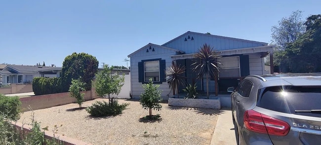 Home entrance, Front yard, patio, and designated parking space on driveway. - 4092 Howard Ave