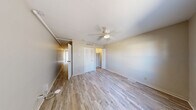 Located at 300 E Shelbourne Dr in Normal, IL, this two-bedroom, one-bathroom unit offers a practical and efficient single-floor layout. Light wood-style flooring runs throughout the space, creating a clean and cohesive look across every room. The entry area features a ceiling fan with light fixture and a window that brings in natural light with views of the surrounding neighborhood. The kitchen is well-equipped with taupe shaker-style cabinetry, a stainless steel refrigerator, gas range, over-the-range microwave, and a double-basin sink with ample counter space. A pantry-style open closet provides additional kitchen storage. The generously sized primary bedroom includes a ceiling fan, louvered bi-fold closet doors, and a dedicated walk-in closet, offering substantial storage. The second bedroom features a window with natural light, light-toned walls, and wood-style flooring consistent with the rest of the unit. The bathroom is outfitted with a full tub-shower combination and a toilet. A dedicated closet off the hallway adds further organizational space. Neutral wall tones and consistent flooring throughout contribute to a bright, functional, and move-in-ready living environment.