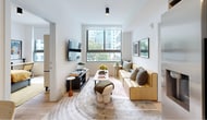 Located in Miami's vibrant Wynwood Arts District, this modern unit at 51 NW 28th St offers three bedrooms and three full bathrooms across a well-designed single-floor layout. The living room is bright and inviting, anchored by a large window framing urban views of the surrounding cityscape, with light wood flooring flowing throughout the space. The kitchen is thoughtfully outfitted with full-height concrete-finish cabinetry, white quartz countertops, and a complete suite of stainless steel appliances including a French door refrigerator, dishwasher, electric range, and built-in microwave. Each bedroom is compact yet functional, featuring large windows that draw in natural light and views of the neighborhood. The primary bedroom offers dedicated space for a desk and workspace area. The three bathrooms maintain a clean, modern aesthetic with white tile walls, dark mosaic tile flooring, concrete-finish vanities, and frameless mirrors. One bathroom features a walk-in shower with full-height white tile surround, while others include shower-tub combinations. The overall design palette is crisp and contemporary, emphasizing clean lines, neutral tones, and efficient use of space throughout.