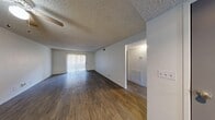 Located at 5055 East Charleston Boulevard in Las Vegas, Nevada, this single-floor residence offers a functional and well-organized layout with two bedrooms, two bathrooms, a living room, kitchen, hallway, entrance, and two closets. Throughout the home, wood-style flooring provides a consistent, clean aesthetic that ties the spaces together.

The living room is a comfortable, open area featuring a textured ceiling, a ceiling fan, and a sliding glass door fitted with vertical blinds that allows ample natural light to fill the room. The space connects easily to the rest of the home via a central hallway.

The kitchen is equipped with gray cabinetry, light marble-style countertops, a double stainless steel sink, and a dishwasher, offering efficient functionality in a tidy layout.

The primary bedroom is a well-proportioned retreat with wood-style flooring and a window with vertical blinds that provides outdoor views and natural light. The second bedroom is equally inviting, also featuring wood-style flooring and access to the hallway.

Both bathrooms are finished with gray vanity cabinetry, white countertops, mirrored medicine cabinets, and tub-shower combinations, maintaining a clean and consistent style. Two closets provide practical storage throughout the home.