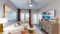 Located in Rockledge, FL, this well-appointed 2-bedroom, 2-bathroom residence offers a thoughtfully designed single-level layout. The open-concept kitchen is a standout, showcasing white shaker cabinetry, quartz countertops, a subway tile backsplash, stainless steel appliances including a range, microwave, dishwasher, and refrigerator, along with a central island with bar seating and pendant lighting. Wood-look plank flooring flows seamlessly throughout the living areas and bedrooms, creating a cohesive aesthetic.

The generously sized primary bedroom features a ceiling fan, large windows with natural light, and access to a walk-in closet with built-in wire shelving. Its en-suite bathroom is equipped with a dual-sink vanity, a glass-enclosed shower, and wood-look tile flooring. The second bedroom is equally comfortable, with a ceiling fan and ample closet space. The second bathroom offers a single vanity and a shower-tub combination.

A dedicated dining area complements the living space, while a private balcony provides an inviting outdoor retreat. The overall design balances modern finishes with a warm, neutral palette, creating a clean and functional living environment.