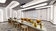 Located at 2140 N Miami Ave in Miami's vibrant Wynwood neighborhood, this thoughtfully designed screening and lounge room offers a compelling blend of cinematic functionality and contemporary interior design. The space is anchored by a ceiling-mounted projector paired with a large projection screen on the front wall, making it well-suited for movie nights, presentations, or group viewings. Plush, oversized seating in neutral tones is arranged to face the screen, accented by mustard yellow and olive green throw pillows that contribute warmth and personality to the room. A sleek green console table runs centrally through the space, styled with books, gold decorative objects, and accent lamps, while bar-height stools line one side for additional seating flexibility. One of the most distinctive architectural features is the series of tall, illuminated arched niches set into the white walls, casting a soft, ambient glow that adds depth and a sculptural quality to the interior. The ceiling features a contrasting dark gray recessed field with rounded, capsule-shaped white light panels that echo the arch motif found on the walls. Underfoot, a bold black-and-white geometric patterned carpet grounds the room with graphic energy. The overall ambiance is modern, curated, and inviting—ideal for social gatherings in a well-appointed communal setting.