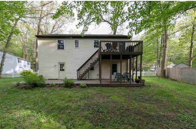 Fenced in back yard with patio and deck - 30 Casino Dr