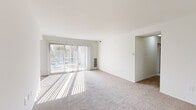 Located at 1420 Key Pkwy in Frederick, MD, this single-floor, 3-bedroom, 1-bathroom home offers a well-organized and functional layout. The living area is bright and welcoming, featuring plush carpeting and large sliding glass doors dressed with vertical blinds that flood the space with natural light and provide access to outdoor views of green, landscaped grounds. The open flow from the living area connects seamlessly to the kitchen, which is equipped with warm wood cabinetry, light stone countertops, stainless steel appliances including a gas range and refrigerator, and wood-look flooring. A pass-through window further connects the kitchen to the living space, enhancing the open feel. The three bedrooms are carpeted and well-lit, with the primary bedroom offering a comfortable footprint and natural light from surrounding windows. The bathroom is clean and bright, featuring classic white hexagonal tile flooring, a vanity with ample counter space, and a well-lit mirror. A dedicated in-unit laundry room with wood-look flooring and a full washer and dryer adds everyday convenience. A closet rounds out the functional amenities of this practical and comfortable home.