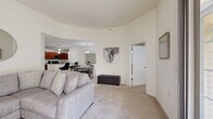 Located at 1 Ascot Cir in Saratoga Springs, NY, this well-appointed 2-bedroom, 2-bathroom residence offers a thoughtfully designed single-floor layout with a comfortable and functional flow throughout.

The open-concept living and dining area serves as the heart of the home, featuring vaulted ceilings that lend an airy sense of spaciousness. Large sliding glass doors flood the living room with natural light and provide direct access to a private balcony with outdoor views. The space transitions seamlessly into the dining area, anchored by a stylish pendant light fixture.

The kitchen is well-equipped with rich cherry wood cabinetry, granite countertops, stainless steel appliances including a refrigerator, range, microwave, and dishwasher, and durable hardwood-style flooring. A peninsula with an undermount sink and pendant lighting connects the kitchen to the dining area.

The generously sized primary bedroom features plush carpeting and ample closet space, with a calm, neutral palette. The second bedroom is equally inviting, benefiting from a large window that brings in natural light. Both bathrooms are finished with tile flooring, granite-topped vanities, and shower-tub combinations. A utility room and hallway complete this well-rounded home.