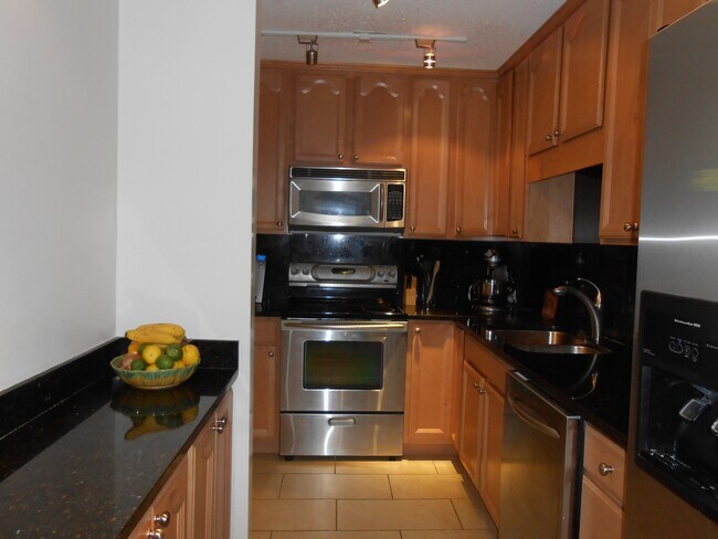 Galley kitchen with maple cabinets and granite counters - 903 E Franklin St