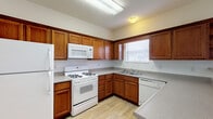 Located at 1 Village Gate Blvd in Delaware, Ohio, this two-floor residence offers a practical and comfortable layout designed for everyday living. The kitchen is well-equipped with rich warm-toned wood cabinetry, ample upper and lower storage, a gas range, built-in microwave, dishwasher, and a full-size refrigerator. Light-toned countertops complement the cabinetry, and a window above the sink brings in natural light. A peninsula counter connects the kitchen to the adjacent living area, which features neutral carpet flooring and a sliding glass door that opens to an outdoor view, filling the space with additional natural light. The carpeted bedrooms are generously sized, each featuring windows with blinds that allow for adjustable natural lighting and neutral walls that provide a clean, versatile backdrop. The bathrooms are finished with wood-toned vanity cabinetry, speckled countertops, a large mirror, and chrome hardware accents. At least one bathroom includes a full tub and shower combination with a chrome curtain rod. Light tile flooring runs throughout the bathrooms, adding a clean, cohesive finish. Overall, the space presents a straightforward, well-maintained design with consistent neutral tones throughout both floors.