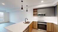 This contemporary 790 square foot apartment in Redmond, WA offers a harmonious blend of style and functionality. The space features two bedrooms, including a spacious primary bedroom of 190 square feet, and one bathroom. The open-concept design seamlessly integrates the kitchen and living area, creating an airy and inviting atmosphere.

The kitchen is a standout feature, boasting sleek wooden cabinetry, stainless steel appliances, and crisp white quartz countertops. Modern pendant lighting adds a touch of sophistication, while the kitchen island provides additional workspace and casual dining options.

Throughout the apartment, wood-style flooring lends warmth and durability. Large windows in the living area and bedrooms flood the space with natural light and offer scenic views. The bathroom is tastefully appointed with modern fixtures, including a combination tub and shower.

For added convenience, the apartment includes an in-unit laundry room with stacked washer and dryer. The neutral color palette and clean lines throughout create a canvas for personal style. This well-designed apartment offers a perfect balance of comfort and contemporary urban living in the heart of Redmond.