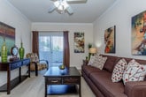 This single-floor residence offers a thoughtfully designed layout that balances comfort and functionality across its key living areas. The living room serves as the heart of the home, featuring plush carpeting, crown molding, a ceiling fan with light fixture, and a sliding glass door that opens to an outdoor area, allowing natural light to fill the space. Double doors provide additional storage, enhancing the room's practicality.

The galley-style kitchen is efficiently organized with white cabinetry, granite-look countertops, wood-look flooring, and a full suite of white appliances. A window above the sink brings in natural light and adds an airy quality to the cooking space.

Adjacent to the living area, the dedicated dining space features neutral carpet and ample wall space, creating a comfortable setting for meals and gatherings.

The bedroom is generously sized with plush carpet, a ceiling fan, a window with blinds, and access to a walk-in closet. The en-suite or nearby full bathroom includes a wide vanity with white cabinetry, a combination tub and shower with sliding glass doors, and wood-look flooring, offering a clean and functional retreat.

Overall, the residence presents a cohesive, neutral palette throughout, with consistent finishes that create a warm and inviting atmosphere.