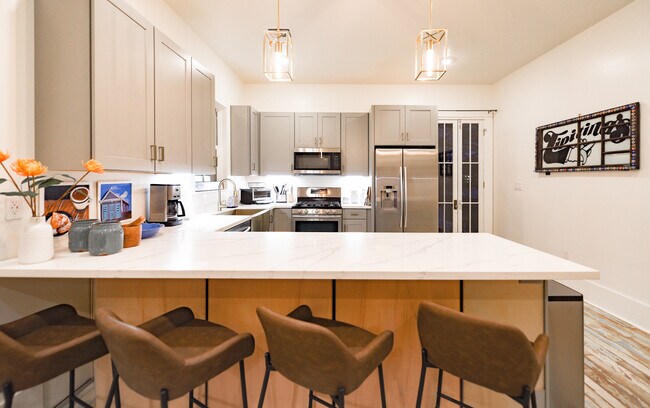 Large kitchen bar easily seats four people - 625 Louisa St