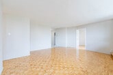Located at 6161 Bathurst Street in North York, Toronto, this 3-bedroom, 1-bathroom unit offers a practical and well-laid-out floor plan across a single level. Classic parquet wood flooring runs throughout the living areas and bedrooms, lending warmth and a timeless character to the space. The generously sized primary bedroom is bathed in natural light through large floor-to-ceiling windows that frame views of the surrounding North York skyline and green spaces, with baseboard heating running beneath the windows. The two additional bedrooms are similarly bright, each featuring parquet flooring and windows that invite natural light. The kitchen has been updated with grey cabinetry, light granite-style countertops, a double sink, and marble-effect tile flooring, providing a clean and functional cooking space with ample storage. The bathroom features a full-size soaker tub and shower combination, finished with white subway-style wall tiles and chrome fixtures for a clean, classic look. A dedicated closet provides additional storage. The open living area connects seamlessly to the kitchen and bedrooms, creating a cohesive and easy-to-navigate layout. The unit's bright, neutral palette and consistent flooring throughout give it a unified and welcoming ambiance.