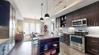 This 640 square foot apartment in Dallas, TX offers a blend of efficiency and style. The single-floor layout maximizes space utilization, featuring one 150 square foot bedroom and an impressive three bathrooms. The heart of the home is the open-concept kitchen and living area, where dark wood cabinetry contrasts beautifully with stainless steel appliances and a granite-topped island. Modern pendant lighting and wood-look flooring enhance the contemporary aesthetic.

The bedroom, though compact, is thoughtfully designed with large windows for natural light, plush carpeting, and a statement headboard. Bathrooms showcase sleek finishes, including vertically-laid white tile and modern fixtures. A dedicated laundry area and walk-in closet offer practical storage solutions.

The living room boasts floor-to-ceiling windows, flooding the space with light and providing city views. Stylish furnishings, including a unique wooden coffee table and designer bookshelf, add character to the space. Despite its modest square footage, this apartment delivers on both functionality and modern urban living, perfect for those seeking a low-maintenance yet high-quality lifestyle in the heart of Dallas.