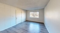 Located at 1720 Van Heise Street in Columbia, SC, this two-bedroom, one-bathroom single-story home offers a practical and functional layout with consistent finishes throughout. Light gray laminate wood flooring runs through the main living areas and bedrooms, giving the home a cohesive, updated feel.

The galley-style kitchen is well-appointed with warm wood cabinetry, light granite-look countertops, a double stainless steel sink, and black appliances including a gas range, refrigerator, microwave, and dishwasher. A textured ceiling adds character to the space.

The combined kitchen and living area flows efficiently, providing a comfortable everyday living space. Both bedrooms feature ceiling fans with light fixtures, large windows that invite natural light and outdoor views of surrounding greenery, and the same light laminate flooring. The primary bedroom offers a generous footprint, while the second bedroom provides a bright, open feel with a closet and paneled wall detail.

The bathroom is cleanly finished with a wood-toned vanity, white countertop, a shower-tub combo, and a mirrored medicine cabinet, all set against neutral walls and wood-look flooring. Two hallways connect the rooms efficiently, and a dedicated closet provides additional storage. The home's neutral palette throughout makes it easy to personalize.
