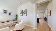 This well-appointed single-story home in Temple, Texas offers four bedrooms and three bathrooms across a generously sized floor plan designed for comfortable living. The interior is finished with light wood-look flooring throughout the main areas, crisp white trim, and a neutral color palette that creates a bright, cohesive feel.

The open-concept living room features vaulted ceilings, recessed lighting, a ceiling fan, and a front-facing door that allows natural light to fill the space. It flows seamlessly into a second sitting or flex area, also accented by vaulted ceilings and tasteful wall art. The kitchen is a standout, showcasing white shaker cabinetry, a white subway tile backsplash, quartz countertops, stainless steel appliances, and a large island with seating — ideal for both meal prep and casual dining.

The primary bedroom is a comfortable retreat with vaulted ceiling details and ample natural light. Its en-suite bathroom features marble-look tile flooring, a walk-in glass shower, a white dual-sink vanity, and a clean, spa-like aesthetic. Additional bedrooms are well-sized with light flooring and double-door closets. The dedicated laundry room includes washer/dryer hookups and marble-look tile flooring, adding practical convenience to this thoughtfully designed home.