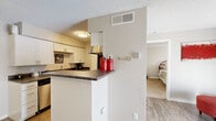 Located at 4155 Lacy Ln in Colorado Springs, CO, this efficient one-bedroom, one-bathroom unit offers a well-organized single-floor layout that maximizes every square foot. The living room is bright and welcoming, featuring durable wood-style flooring and a large sliding glass door fitted with vertical blinds that invite generous natural light and provide outdoor views. The kitchen is designed with practicality in mind, showcasing white cabinetry with brushed nickel hardware, dark granite-style countertops, a stainless steel sink, and a full-size refrigerator. A peninsula counter separates the kitchen from the main living area, creating an open and connected feel throughout. The bedroom is a comfortable retreat with plush carpeting, a window with blinds for natural light and privacy, and a built-in closet offering ample storage. The bathroom features a full tiled tub-and-shower combination with classic tile surround accented by a dark border, complemented by white cabinetry above for additional storage. Textured ceilings are consistent throughout the unit. The overall layout is compact yet functional, making this Colorado Springs residence a practical and comfortable living space.