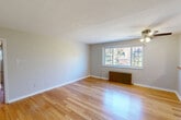 Located at 273 S Winebiddle St in Pittsburgh's Bloomfield neighborhood, this two-bedroom, one-bathroom unit is thoughtfully laid out across a single floor. Warm hardwood flooring extends throughout the main living areas, reflecting natural light from multiple windows and lending the space a bright, inviting ambiance. A ceiling fan in the main living area adds both function and comfort, while classic cast-iron radiators provide character and efficient heating throughout.

The kitchen features warm honey-toned wood cabinetry, stone-look countertops, a mosaic tile backsplash, and tile flooring. A pass-through counter connects the kitchen to the adjacent living space, enhancing the open feel. The combined kitchen and living room layout encourages a natural flow ideal for everyday living.

The primary bedroom is generously sized, offering two windows with outdoor views and a cast-iron radiator, while the second bedroom is carpeted and provides comfortable, private accommodations. Two closets offer ample storage throughout.

The bathroom is finished with a granite-topped vanity, a mirrored medicine cabinet, white tile surround, and a tub-shower combination. A hallway connects all rooms efficiently, and the entrance provides a welcoming transition into the home. The unit offers a practical, well-maintained living environment with timeless details throughout.