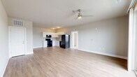 Located at 6200 Centurion Cir in Huber Heights, Ohio, this 1-bedroom, 1-bathroom unit offers a thoughtfully designed, single-floor layout. The open-concept living and kitchen area forms the heart of the space, featuring light wood-style flooring that adds warmth throughout. The kitchen is equipped with white cabinetry, a double-basin sink, a dishwasher, a black refrigerator, and a range, providing a clean and functional setup. The living area extends generously from the kitchen, enhanced by a ceiling fan and a sliding glass door that fills the room with natural light and opens to an outdoor view. The bedroom is carpeted for comfort, accented by a ceiling fan, and includes multiple windows that bring in additional natural light and scenic outdoor views. Neutral, soft-toned walls throughout the unit create a calm and cohesive aesthetic. The bathroom features a full tub-shower combination and continues the light wood-style flooring. A dedicated laundry area includes a full-size washer and dryer, adding everyday convenience. White trim and baseboards throughout tie the space together with a crisp, clean finish.