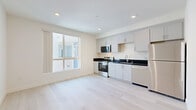 Located at 433 Rosenell Terr in the Silver Lake neighborhood of Los Angeles, this modern 1-bedroom, 2-bathroom unit offers a thoughtfully designed single-floor layout with clean, contemporary finishes throughout. Light-toned hardwood flooring flows seamlessly across every room, creating a bright and cohesive aesthetic.

The kitchen is a standout feature, outfitted with white shaker-style cabinetry, dark granite countertops, and a full suite of stainless steel appliances including a range, microwave, dishwasher, and refrigerator. A large window fills the kitchen and adjacent living area with natural light, enhancing the open feel of the space.

The bedroom is a well-proportioned retreat featuring a sliding mirrored closet door, a window with natural light, and the same warm wood flooring found throughout. A connecting hallway with louvered closet doors adds practical storage.

Both bathrooms are finished in a modern style, with one featuring a soaking tub and shower combo with large white subway tile surround, built-in niche shelving, a dark granite vanity, and recessed lighting. The overall design palette — crisp white walls, light floors, and dark stone counters — creates a clean, minimalist ambiance well-suited to contemporary urban living.