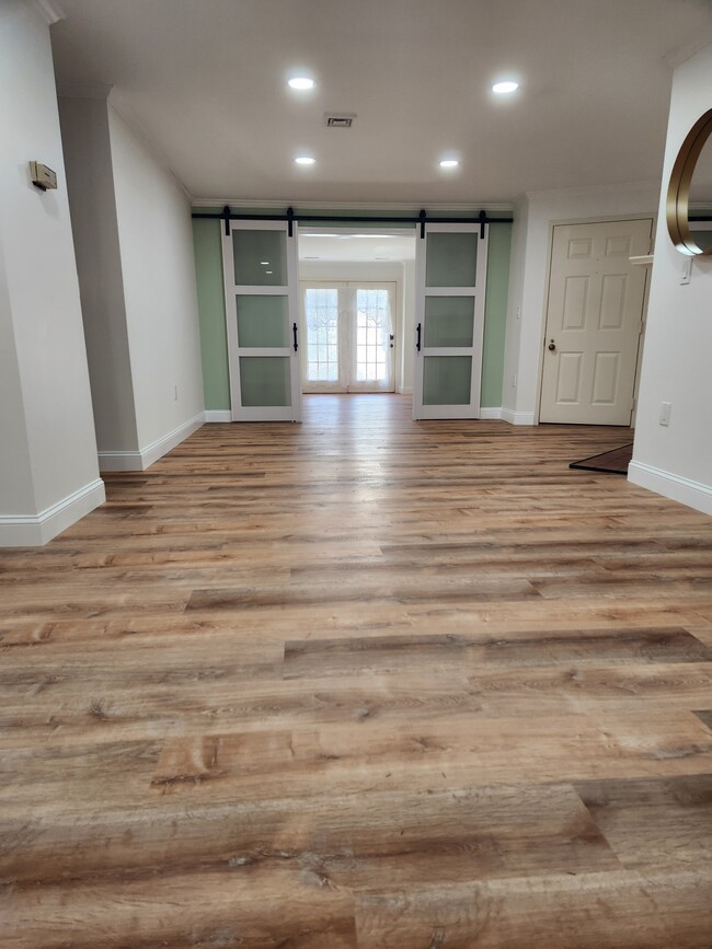Living room looking into second bedroom/office with double barn doors - 1 Highland Ct
