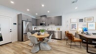 Located at 13993 Foothill Blvd in Fontana, CA, this two-story home offers 2 bedrooms, 4 bathrooms, a dedicated office, and thoughtfully designed living spaces across two floors. The ground floor is anchored by a well-appointed kitchen featuring gray shaker cabinetry, a white subway tile backsplash, stainless steel appliances including a gas range, built-in microwave, and French door refrigerator, all complemented by light wood-style flooring that flows throughout. A half bathroom on this level showcases bold blue textured wallcovering and a gray vanity, adding a distinctive design touch. The upper floor hosts both bedrooms, including a spacious primary bedroom with balcony access, abundant natural light, and warm neutral tones. The primary bathroom features a dual-sink vanity with white quartz countertops and gray cabinetry with matte black hardware. A dedicated walk-in closet with built-in shelving and hanging rods provides excellent storage. The secondary bedroom is cozy and bright, accented with eclectic wall décor and ample closet space. An additional office and hallway complete the upper level. Recessed lighting, consistent wood-style flooring, and a clean, modern aesthetic unify the space throughout.