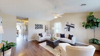 Located at 2010 Judy Rae Ave in Alliance, Ohio, this well-appointed single-story home offers a thoughtfully designed layout across three bedrooms and one bathroom. The living room serves as the heart of the home, featuring rich hardwood-style flooring, vaulted ceilings, a ceiling fan, and abundant natural light streaming through large windows. The space flows seamlessly into a dedicated dining area, also adorned with hardwood-style floors, where a rear-entry door provides convenient outdoor access. The kitchen is equipped with warm wood cabinetry, granite-style countertops, a peninsula with bar seating, and a window that brings in natural light. A full bathroom features a rich wood vanity with granite countertops, a large mirror, and hardwood-style flooring. The spacious primary bedroom offers ample room to unwind, while the additional bedrooms are carpeted and bright, each with windows overlooking the outdoors. Two closets — including a walk-in with multi-tier wire shelving and hardwood-style flooring — provide excellent storage. Neutral warm-toned walls and textured ceilings are consistent throughout, lending the home a cohesive and inviting character.