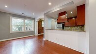 Located in the heart of West Hollywood on N Flores Street, this single-floor residence offers a thoughtfully designed layout that maximizes its comfortable footprint. Rich hardwood flooring flows throughout every room, lending warmth and continuity to the entire space.

The open-concept kitchen and living area serves as the heart of the home. The kitchen is well-equipped with rich cherry wood cabinetry, granite countertops, a stone tile backsplash, stainless steel appliances including a refrigerator and gas range, and a striking custom range hood. A peninsula counter separates the kitchen from the living area, ideal for casual dining or entertaining. Recessed lighting illuminates the space throughout.

The living room is highlighted by a distinctive exposed brick accent wall that adds character and texture, complemented by crown molding and a large window that draws in natural light and views of the surrounding neighborhood. An arched doorway connects to a secondary living area, which also features generous windows, a closet, and continued hardwood flooring.

The bathroom is finished with classic hex-tile mosaic flooring, subway tile in the tub-shower surround, a granite-topped vanity with white cabinetry, and polished chrome fixtures — balancing timeless style with practical function.