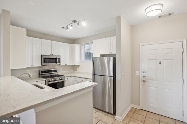 Building Photo - This townhouse style condo is located across the street from the Vienna Metro Station (Orange Line).