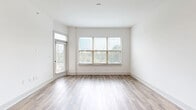 Located at 1924 Monroe Dr NE in Atlanta's vibrant 30324 corridor, this 1-bedroom, 1-bathroom unit offers a thoughtfully designed single-level layout with clean, contemporary finishes throughout. Wood-look plank flooring runs consistently through every room, creating a cohesive and warm aesthetic.

The open-concept kitchen and living area serves as the heart of the unit. The kitchen is outfitted with crisp white shaker cabinetry, black hardware accents, a herringbone tile backsplash, light quartz countertops, and a large peninsula with an undermount sink — ideal for both meal prep and casual dining. Stainless steel appliances, including a range, over-the-range microwave, and French door refrigerator, complete the space. Pendant lighting adds a modern touch above the peninsula.

The living area is bright and open, featuring multiple windows with horizontal blinds that invite natural light while offering privacy. The bedroom is a comfortable, well-proportioned retreat with large windows framing outdoor greenery views. A dedicated closet provides practical storage.

The bathroom features white subway tile walls with matte black fixtures, maintaining the unit's consistent modern aesthetic. A hallway connects the private spaces efficiently. The overall ambiance is clean, bright, and move-in ready, reflecting a modern residential design sensibility.