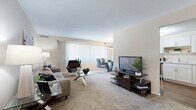 This 1-bedroom, 1-bathroom residence in Bedford, Ohio, offers a thoughtfully designed single-floor layout that maximizes comfort and functionality. The open living room is carpeted and bathed in natural light from large windows fitted with vertical blinds, creating a bright and airy atmosphere. The space comfortably accommodates a full seating arrangement and flows seamlessly into a dedicated dining area, ideal for everyday living and entertaining.

The kitchen features warm hardwood-style flooring, crisp white shaker cabinetry with modern hardware, light countertops, and a full suite of stainless steel appliances, including a range, dishwasher, and refrigerator. A compact dining nook within the kitchen provides a convenient casual eating space.

The bedroom is a comfortable retreat with plush carpeting, a wide window with vertical blinds for natural light and privacy, and a reach-in closet for storage. The neutral color palette and warm lighting contribute to a calm and restful ambiance.

The bathroom is finished in clean white tile, featuring a vanity with under-cabinet storage, an integrated sink, and a mirrored medicine cabinet above. A connecting hallway ties all rooms together efficiently. Overall, this residence offers a clean, modern aesthetic with practical finishes throughout.
