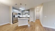 Located at 500 Liberty in Fort Walton Beach, FL, this well-appointed 3-bedroom, 2-bathroom single-story home offers a thoughtfully designed layout with modern finishes throughout. The open-concept kitchen and dining area serves as the heart of the home, featuring sleek gray cabinetry, a full suite of stainless steel appliances, a white tile backsplash, granite countertops, a central island with pendant lighting, and warm wood-look flooring that extends throughout the main living areas. The living room is bright and inviting, highlighted by French doors that allow abundant natural light and provide outdoor access. The spacious primary bedroom includes a generous walk-in closet with built-in wire shelving and plush carpet flooring, while additional bedrooms offer ceiling fans, large windows, and comfortable carpet underfoot. The bathrooms are clean and functional, with one featuring a tiled tub-surround and wood-look flooring. Two well-sized closets add practical storage throughout the home. The neutral color palette, recessed lighting, and consistent finishes create a cohesive and modern ambiance, making this home a comfortable and stylish residence in the heart of Fort Walton Beach.