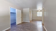 Located at 106 Concord Ave in Anderson, SC, this single-floor unit offers four bedrooms, a living room, kitchen, hallway, and a closet — efficiently arranged to maximize functionality within a compact footprint. Neutral gray walls and crisp white trim create a clean, cohesive aesthetic throughout the home.

The kitchen is a standout feature, outfitted with white shaker-style cabinetry, sleek bar-pull hardware, stone-look countertops, a stainless steel sink, and a gas range. A window with blinds allows natural light to brighten the space while maintaining privacy. Wood-look luxury vinyl plank flooring runs through the kitchen and several of the bedrooms, providing durability and a modern finish.

The four bedrooms are finished with either LVP flooring or neutral wall-to-wall carpet, offering variety and comfort. Several rooms feature windows dressed with horizontal blinds, filling the spaces with natural light. Ceiling fans are present in select bedrooms. The primary bedroom is generously proportioned and includes access to a dedicated closet. White paneled doors with brushed nickel hardware are consistent throughout.

The overall design is clean and move-in ready, with a practical layout and updated finishes that make this unit a functional and comfortable home in Anderson, SC.