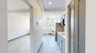 Located at 1216 N Superior St in Spokane, Washington, this efficiently designed studio unit offers a thoughtfully organized single-floor layout. Light wood laminate flooring runs throughout the entire space, creating a cohesive and clean aesthetic. The open main area features crisp white walls, recessed lighting, exposed ceiling beams, and dark baseboards that provide a subtle contrast to the neutral palette. Natural light filters in through multiple windows, offering views of the surrounding neighborhood.

The kitchen is well-appointed with sage green shaker-style cabinetry on both upper and lower levels, a stainless steel sink with a modern gooseneck faucet, a full-size stainless steel refrigerator, and a built-in microwave. The light countertops complement the cabinetry, keeping the space feeling bright and functional.

The bathroom maintains the same clean, contemporary design with a vessel sink atop a gray vanity cabinet, a framed mirror with overhead lighting, and a shower/tub combination. The consistent use of gray tones and light wood flooring ties the bathroom seamlessly into the overall design language of the unit. A baseboard heating system is present throughout, ensuring year-round comfort in this efficiently planned Spokane residence.
