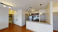 Located at 600 Franklin Ave in Waco, Texas, this single-floor unit offers a well-designed layout that blends functionality with comfortable living. The open-concept kitchen serves as the heart of the space, showcasing dark espresso cabinetry, granite countertops, a white subway tile backsplash, and a full suite of stainless steel appliances including a refrigerator, range, and built-in microwave. A peninsula counter with pendant lighting above provides a natural division between the kitchen and the adjacent living area, which features warm wood-style flooring, a ceiling fan, and windows fitted with horizontal blinds that allow for controlled natural light. A glass-paneled entry door further brightens the living space. The bedroom is carpeted for comfort and includes a ceiling fan and a window with blinds. The bathroom is finished with wood-style flooring, a tub and shower combination accented by classic white tile with a navy blue tile border, a dark-cabinetry vanity with a granite-topped sink, and a large mirror. Throughout the unit, neutral wall tones and consistent finishes create a cohesive and practical living environment well-suited to everyday life in Waco.