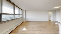 This renovated apartment, located at 10-50 Carabob Crt in Toronto, offers a harmonious blend of comfort and style within its 63 square meters. The open-concept design seamlessly integrates the kitchen and living areas, creating a spacious feel enhanced by large windows that flood the space with natural light. The kitchen boasts sleek white cabinetry, stainless steel appliances, and a marble-look countertop, perfect for culinary enthusiasts. The generously sized bedroom, measuring 16 square meters, provides ample space for relaxation and storage. The bathroom features a clean, modern aesthetic with a white color scheme and updated fixtures. Throughout the apartment, light-toned wood-look flooring adds warmth and continuity. The property's single floor layout ensures ease of movement, while the hallway connects all rooms efficiently. Baseboard heating units along the walls offer comfort during colder months. This thoughtfully designed space combines functionality and contemporary style, making it an ideal urban dwelling in the heart of Toronto.