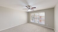 Located at 1030 Old Omen Rd in Tyler, Texas, this single-story, 2-bedroom, 2-bathroom home offers a functional and well-organized layout. The floor plan includes a living room, kitchen, hallway, and a dedicated closet, all arranged efficiently across a single level.

The primary bedroom is a generously sized retreat featuring plush carpeting, neutral gray walls, and a ceiling fan with integrated lighting. A large window with blinds invites natural light and outdoor views, while a spacious walk-in closet with dual shelving rods provides ample storage. The second bedroom also features soft carpeting, neutral tones, and a window that brings in natural light, making it well-suited as a guest room or home office.

The kitchen is outfitted with white cabinetry featuring brushed nickel hardware, speckled stone countertops, and wood-look flooring, giving it a clean and modern appearance. The two bathrooms are finished with speckled countertop vanities, white cabinetry, and mirrors. One bathroom includes a full tub-shower combo with white tile surround and chrome fixtures.

Throughout the home, a consistent neutral color palette, carpeted bedrooms, and bright natural lighting create a clean, move-in-ready atmosphere suited for comfortable everyday living.