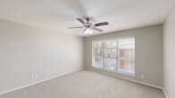 Located at 1030 Old Omen Rd in Tyler, Texas, this single-story, 2-bedroom, 2-bathroom home offers a functional and well-organized layout. The floor plan includes a living room, kitchen, hallway, and a dedicated closet, all arranged efficiently across a single level.

The primary bedroom is a generously sized retreat featuring plush carpeting, neutral gray walls, and a ceiling fan with integrated lighting. A large window with blinds invites natural light and outdoor views, while a spacious walk-in closet with dual shelving rods provides ample storage. The second bedroom also features soft carpeting, neutral tones, and a window that brings in natural light, making it well-suited as a guest room or home office.

The kitchen is outfitted with white cabinetry featuring brushed nickel hardware, speckled stone countertops, and wood-look flooring, giving it a clean and modern appearance. The two bathrooms are finished with speckled countertop vanities, white cabinetry, and mirrors. One bathroom includes a full tub-shower combo with white tile surround and chrome fixtures.

Throughout the home, a consistent neutral color palette, carpeted bedrooms, and bright natural lighting create a clean, move-in-ready atmosphere suited for comfortable everyday living.