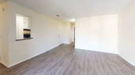 Located at 21227 US Highway 19 N in Clearwater, Florida, this one-bedroom, one-bathroom unit offers a well-organized single-floor layout across a comfortable living footprint. The open living and dining area is finished with durable wood-style flooring and features textured ceilings, neutral cream-toned walls, and a sliding glass door that leads to a private balcony — allowing natural light to fill the space. The balcony provides an outdoor retreat with a railing and exterior window access. The kitchen is designed in a galley style, equipped with white cabinetry, dark granite-style countertops, a stainless steel sink, and black appliances including a refrigerator, range, and dishwasher, complemented by light tile flooring. A pass-through opening connects the kitchen to the dining and living area. The bedroom offers a comfortable sense of space, carpeted flooring, and a large window dressed with vertical blinds that invite natural light and outdoor views. The bathroom features wood-look tile flooring, a tiled shower/tub combination, and a vanity with dark countertops. Three closets throughout the unit provide ample storage, and a hallway connects the main living spaces efficiently. The unit's clean, move-in-ready condition and functional layout make it a practical and comfortable Clearwater residence.